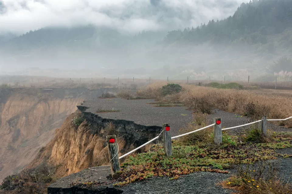 Collapsed road on coastal cliff in California